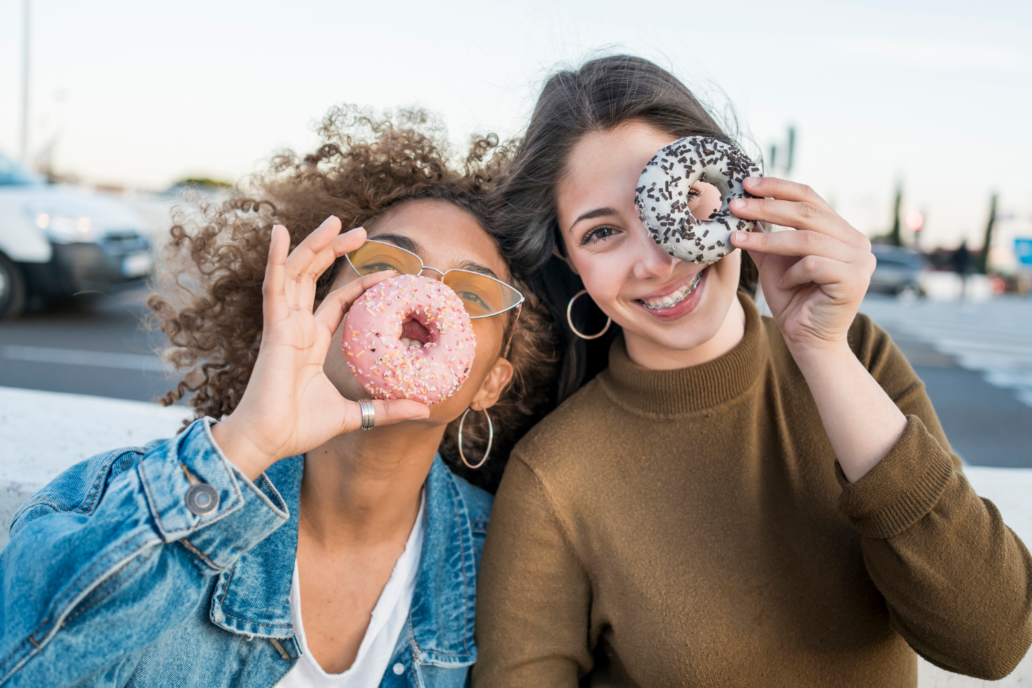Zwei Frauen freuen sich auf Donuts, auch wenn Zucker ungesund ist.